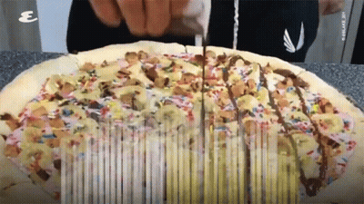 Pizza With Sprinkles Being Sliced GIF