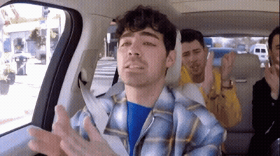 Plaid Shirt Man In Car Back Seat With Others GIF