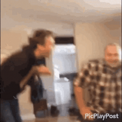 Plaid Shirt Man Standing Next To Another Man GIF