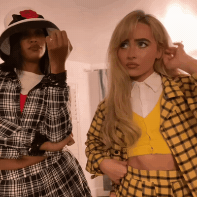 Plaid Shirt Woman Beside Yellow Cardigan Woman GIF