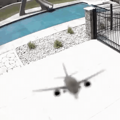 Plane Flying Over Swimming Pool GIF