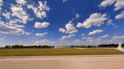 Plane On Runway Blue Sky White Clouds GIF