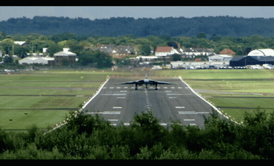 Plane Taking Off On Runway With Trees GIF