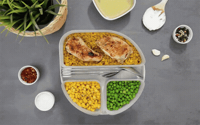 Plate Of Food With Corn Peas And Chicken GIF