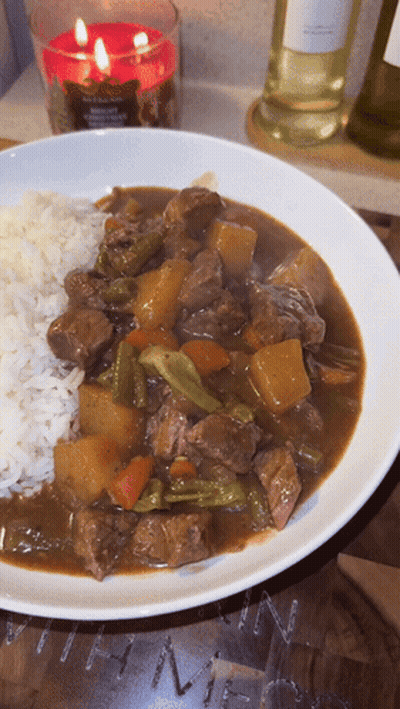Plate Of Stew With Rice And Candle GIF