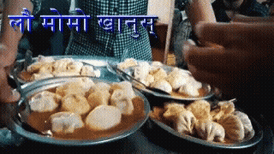 Plates Of Food With Sign Saying Lo Momo GIF