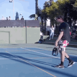 Playful Flipping Pickleball Paddle GIF