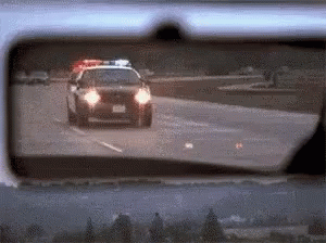 Police Car Driving Down Highway GIF