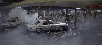 Police Car Number 10 Surrounded By Zombies GIF