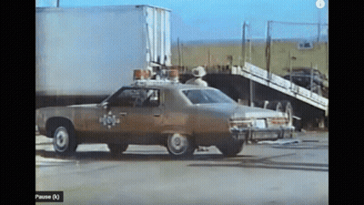 Police Car Parked In Front Of White Truck GIF