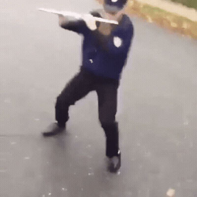 Police Officer Holding Gun On Street GIF