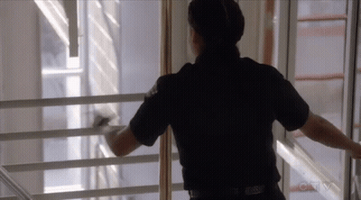 Police Officer Looking Out Window With CBS Logo GIF