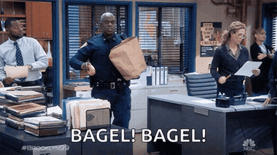 Police Officer Running Through Office Holding Bag And Bagel GIF