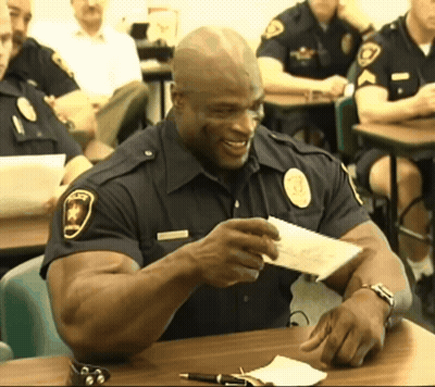 Police Officer Smiling Holding Paper GIF