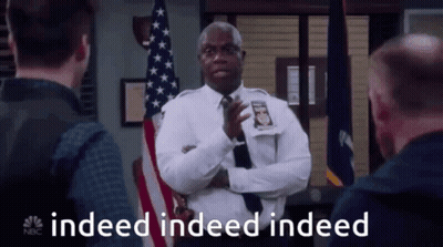 Police Officer Standing In Front Of American Flag GIF