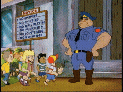Police Officer Standing In Front Of Notice Board GIF