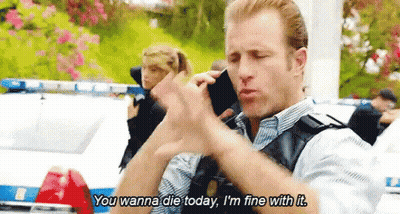Police Officer Talking On Cell Phone In Front Of Police Car And Woman GIF