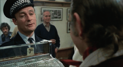 Police Officer Talking To Man In Front Of 3D Machine GIF