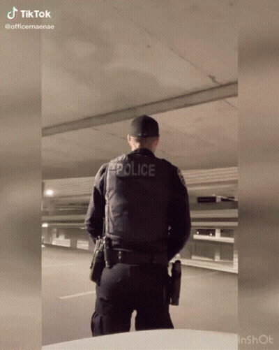 Police Officer With Gun In Parking Garage GIF