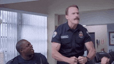 Police Officer With Mustache Standing Next To Another GIF