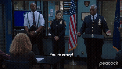 Police Officers In Front Of American Flag Saying How Did You Pull This Off GIF