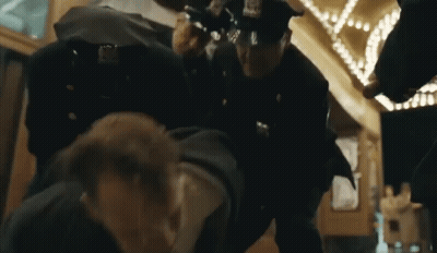 Police Officers Standing Around Man GIF