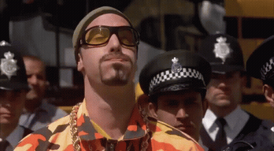 Police Officers Standing Around Man With Sunglasses GIF