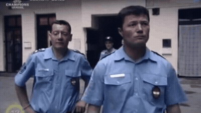 Police Officers Standing In Front Of Champions League Building GIF
