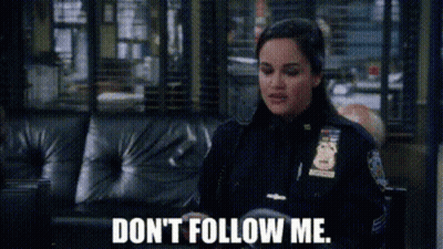 Police Woman Sitting On Couch Don't Follow Me GIF