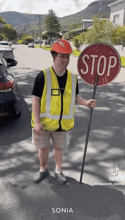 Policeman Singing Into Microphone On Stage GIF