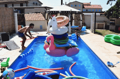 Pool Filled With Floats And Flamingo GIF
