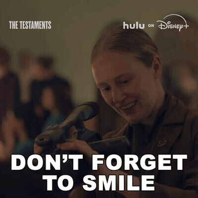 Poster Woman Holding Camera Says Don't Forget To Smile GIF