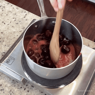 Pot Of Cherry Sauce Stirred On Stove GIF