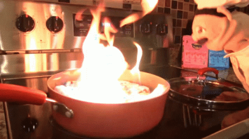 Pot Of Food Cooking On Stove With Pepto Bismol Behind It GIF