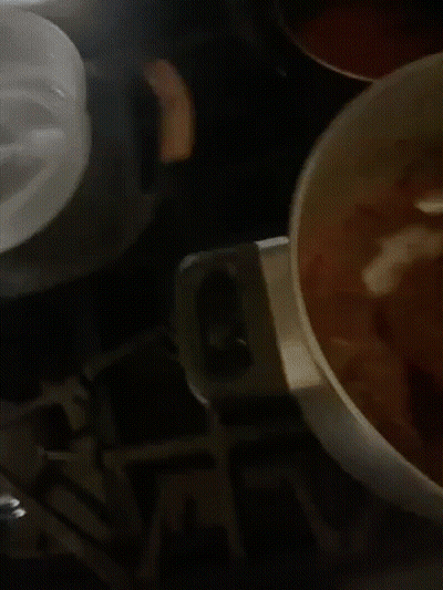 Pot Of Soup With Pink Spoon GIF