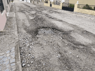 Pothole In Road With Fence Background GIF