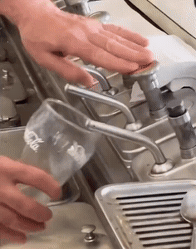 Pouring Water Into Coca Cola Glass GIF