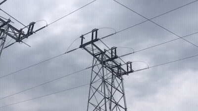 Power Lines Against Cloudy Sky With Tower GIF