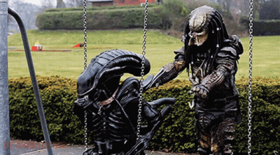 Predator And Alien On Swing Set GIF