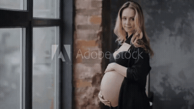Pregnant Woman In Black Dress Holding Belly GIF