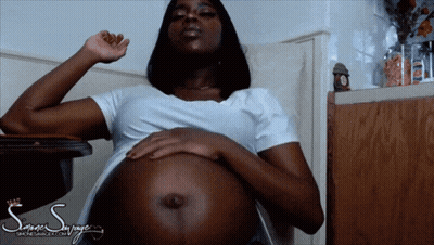 Pregnant Woman Sitting With Hands On Belly GIF