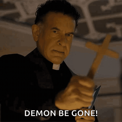 Priest Holding Cross Saying Demon Be Gone GIF