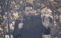 Priest Praying With Cross