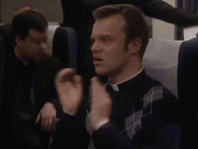 Priest Sitting In Plane With Hands In Air GIF