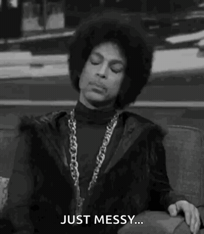 Prince Is Sitting On A Couch In A Black And White Photo And Saying `` Just Messy '' . GIF