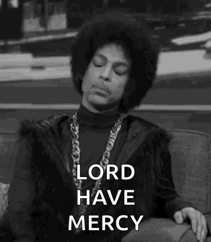 Prince Is Sitting On A Couch With His Eyes Closed And A Necklace Around His Neck . GIF
