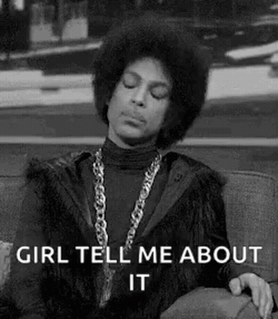 Prince Is Sitting On A Couch With His Eyes Closed And A Necklace Around His Neck . GIF