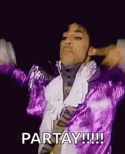 Prince Is Wearing A Purple Jacket And A White Shirt And Is Dancing On Stage . GIF