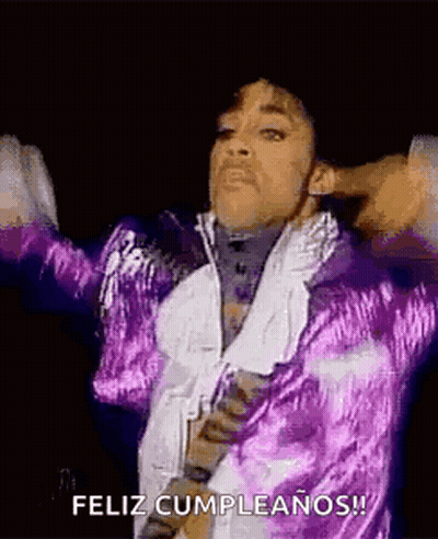 Prince Is Wearing A Purple Jacket And Tie And Is Dancing On Stage . GIF