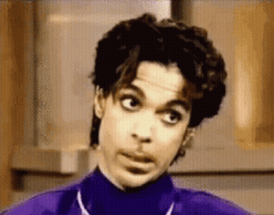 Prince Is Wearing A Purple Turtleneck And Making A Funny Face GIF
